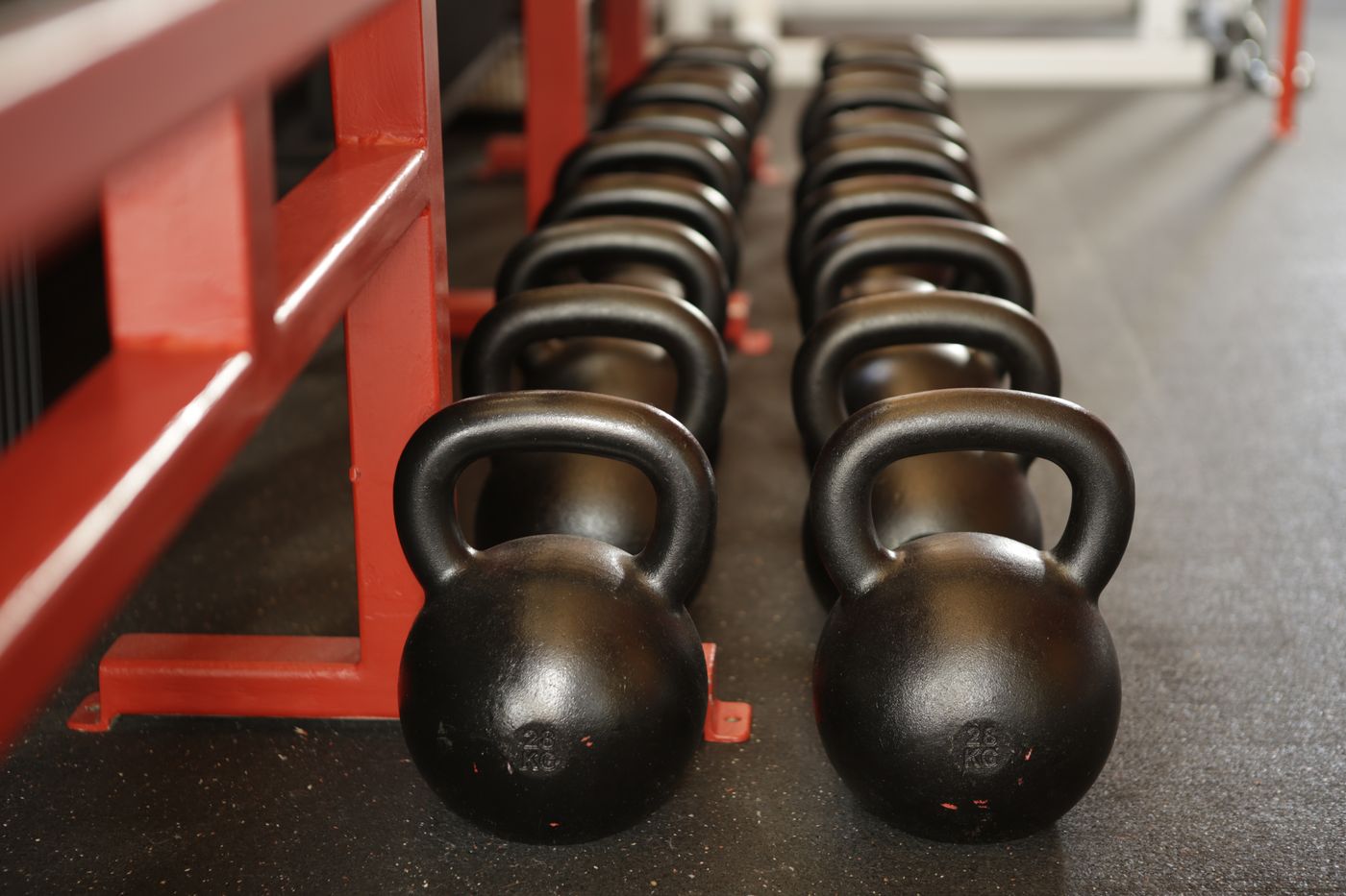 Row of cast-iron kettlebells on the free weights floor