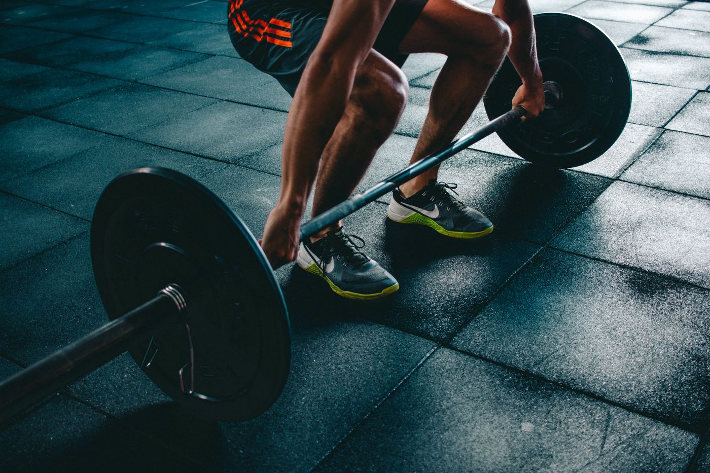 Close view of an athlete at the bottom of a barbell squat